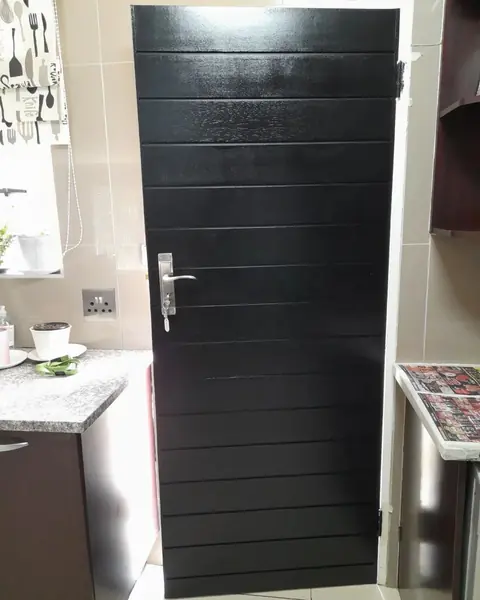 After. Painting job: glossy black slatted kitchen door, closed