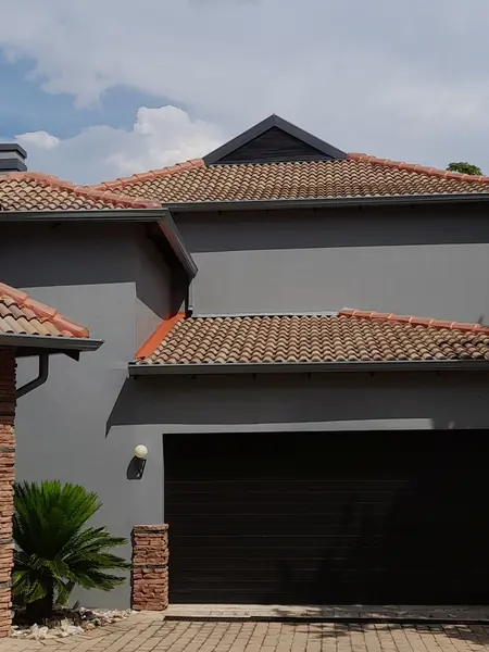 Painting job: same grey house, wider framing, garage door and palm