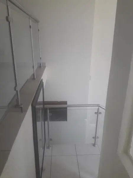 Renovations job: glass balustrade and white stairwell wall, hazy