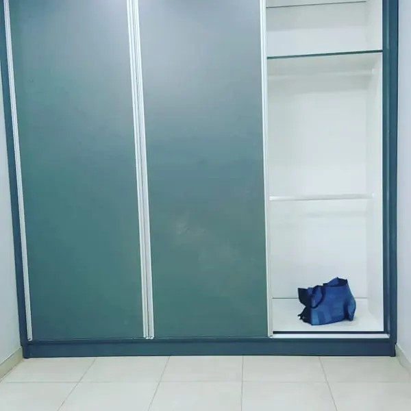 Renovations job: wardrobe with one door open, blue bag inside
