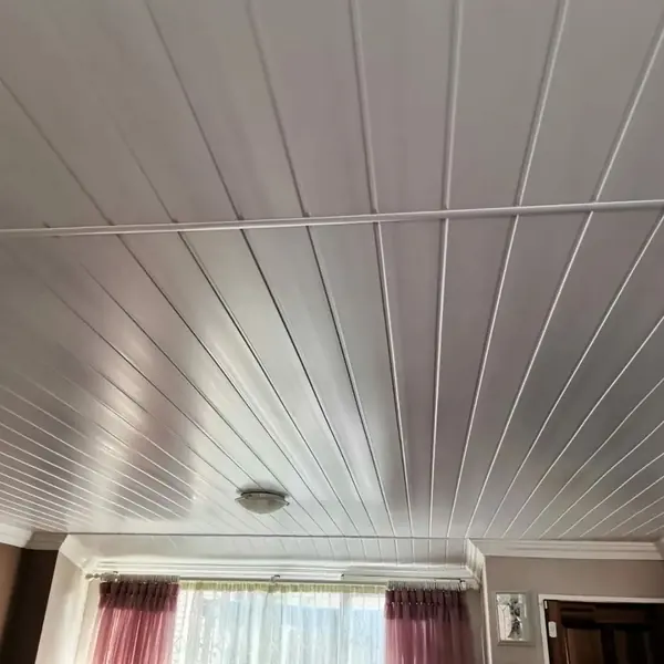 Renovations job: wide white panelled ceiling, cornice, pink curtains below