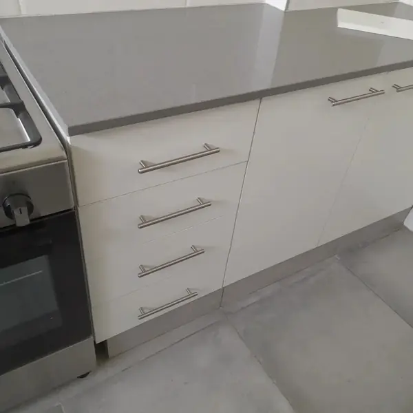 Renovations job: white kitchen drawers, grey floor, stove