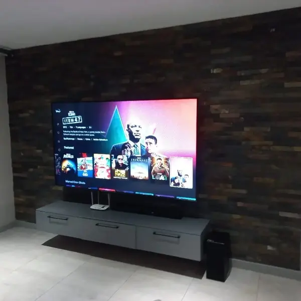 Renovations job: slate stone cladded wall behind wall-mounted TV
